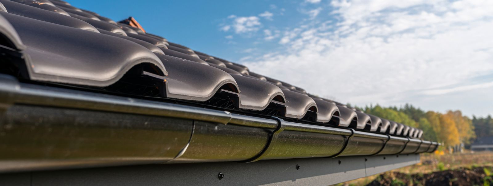 Gutters are an essential component of a building's roofing system, designed to collect and divert rainwater away from the structure. While their primary role is